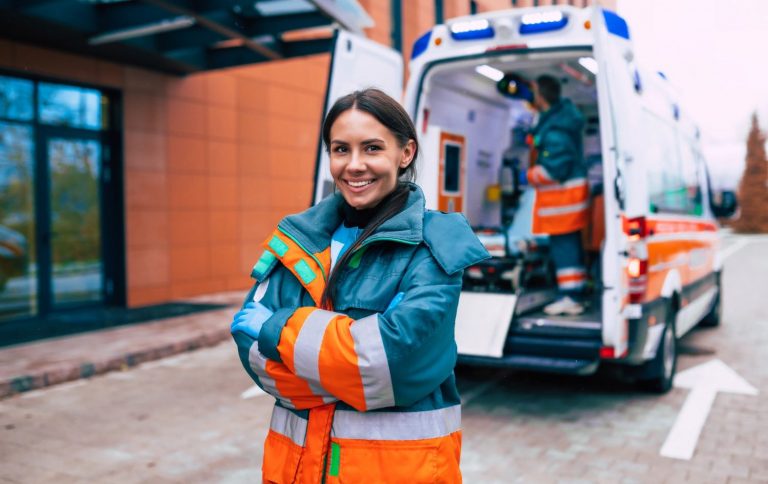 professional confident young woman doctor with ambulance